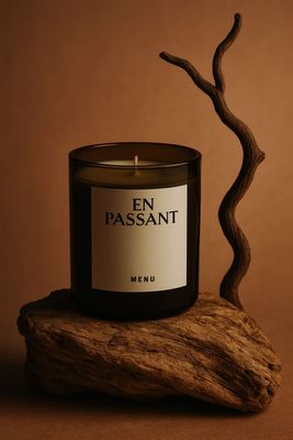 a candle sitting on top of a piece of wood
