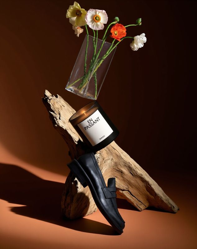 a vase of flowers sitting on top of a piece of wood