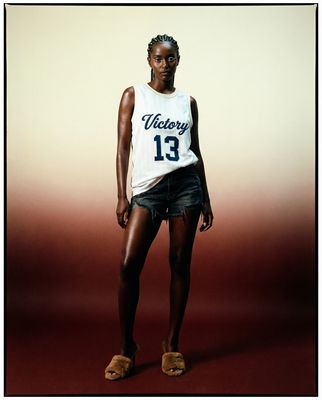 a woman in a white shirt and black shorts