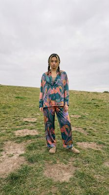 a woman standing on top of a lush green field