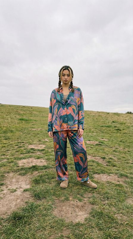 a woman standing on top of a lush green field