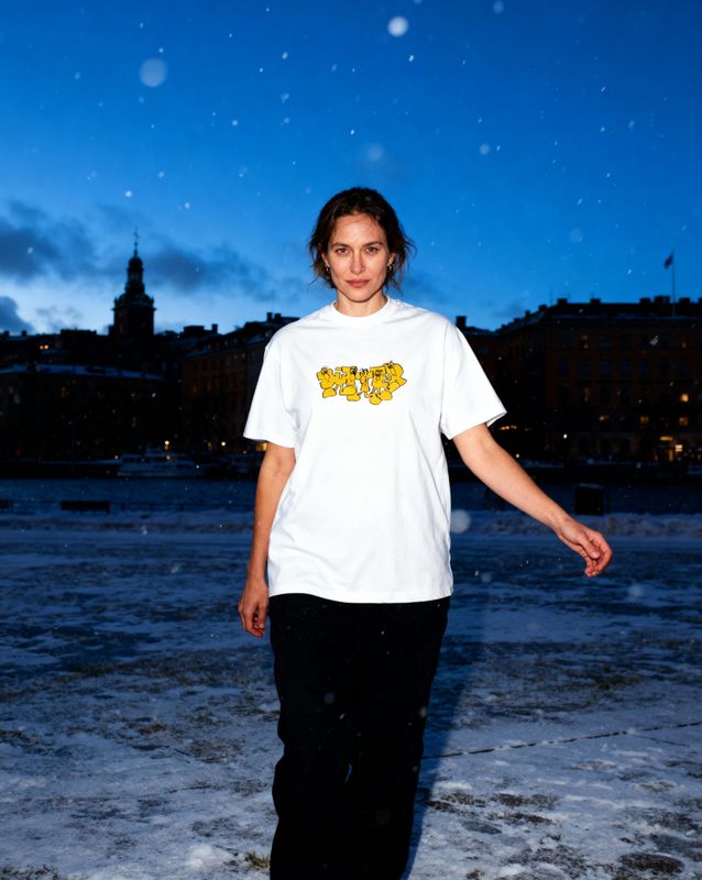 a woman standing in the snow in front of a building