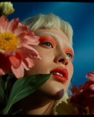 a woman with a flower in her hand