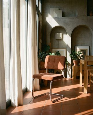 a chair sitting in a room next to a window