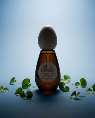 a bottle of honey with leaves around it