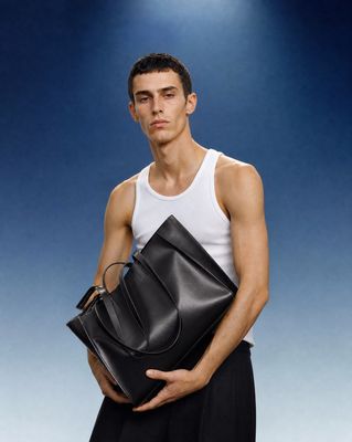 a man holding a black bag in his hands