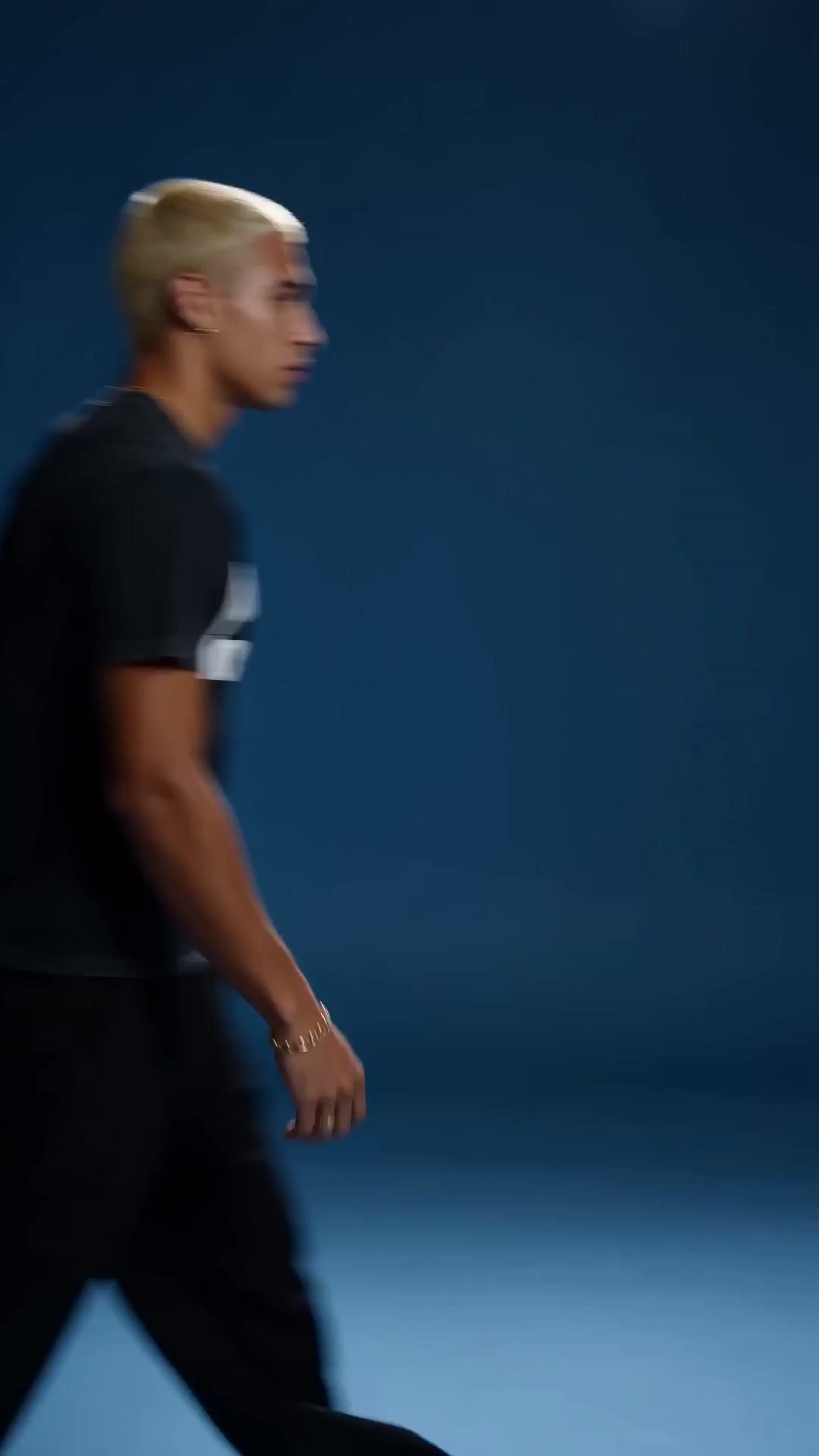 a man in a black shirt is walking