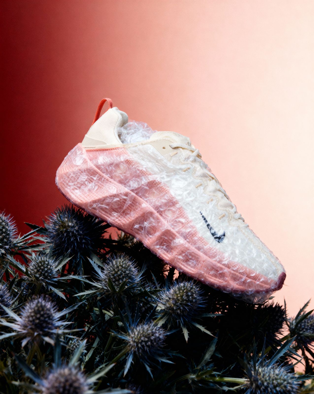 a pair of shoes that are on top of a plant