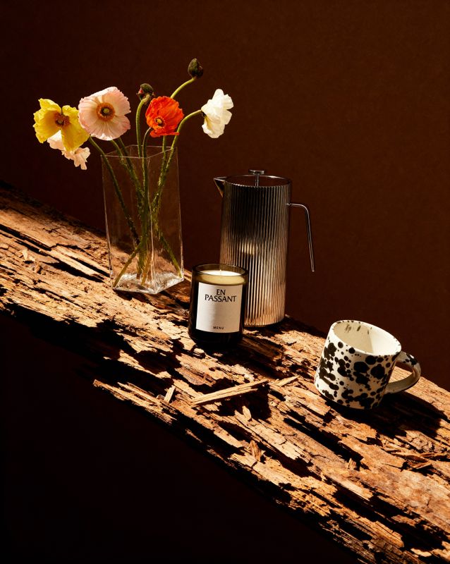 a wooden table topped with a vase filled with flowers