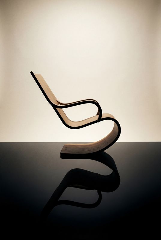 a chair sitting on top of a black table