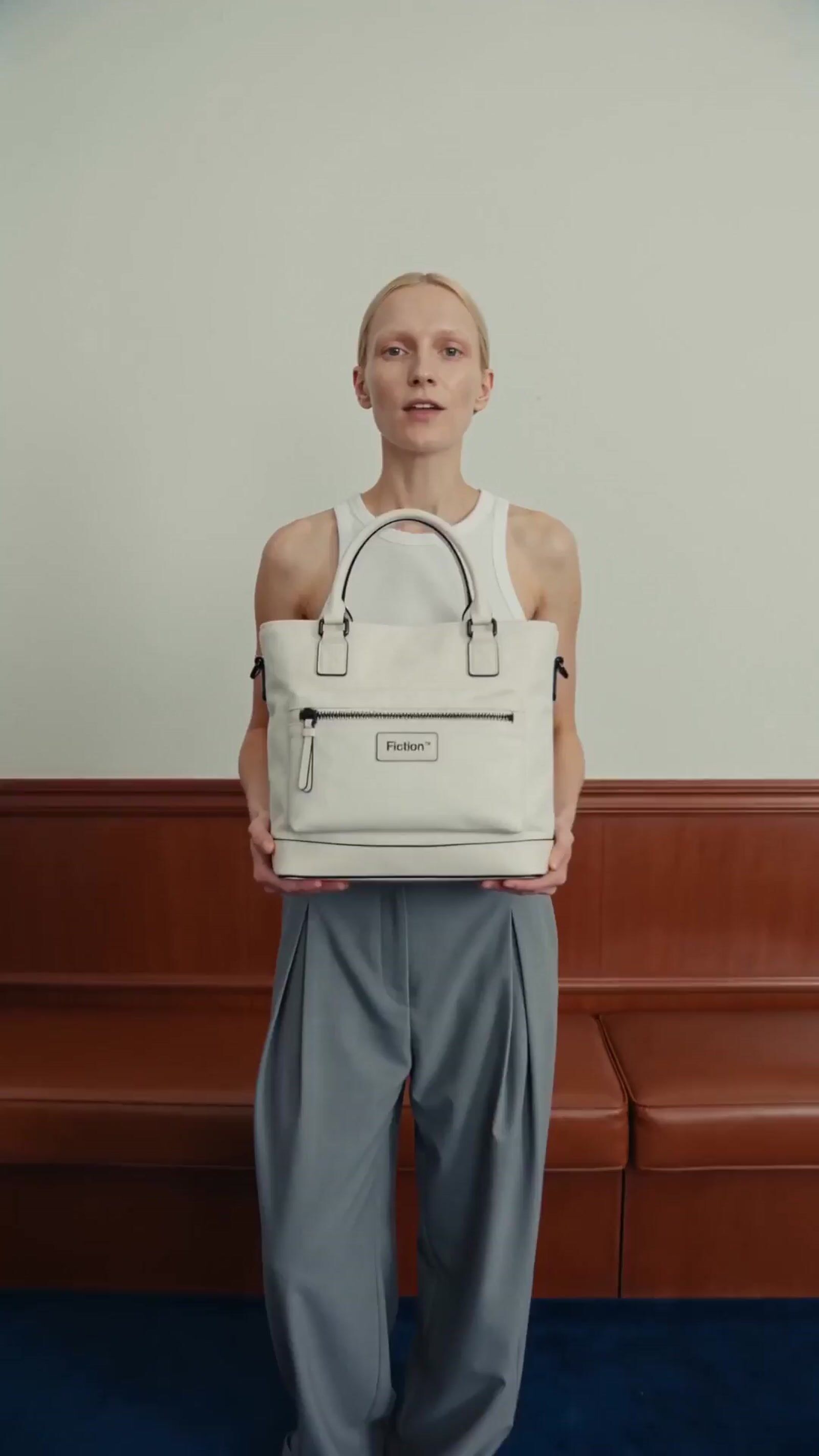 a woman holding a white bag in front of her face
