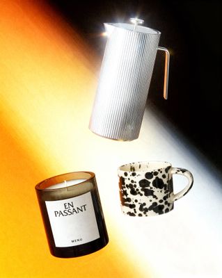 a candle and a cup on a table