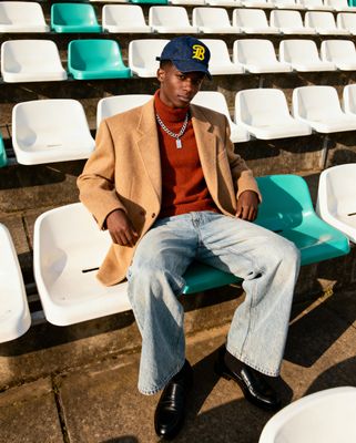 a man sitting on a bench in a stadium