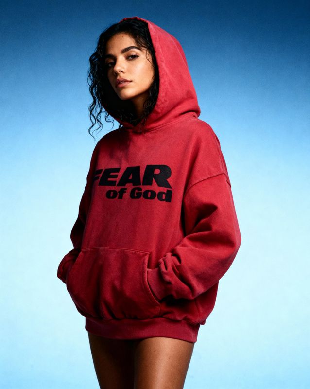 a woman in a red hoodie that says fear of god