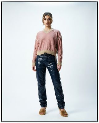 a woman standing in front of a white background