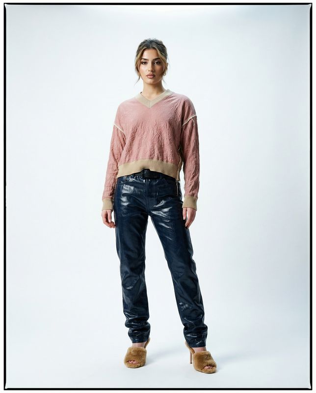 a woman standing in front of a white background