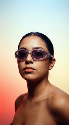 a woman with sunglasses on her head is posing for a picture