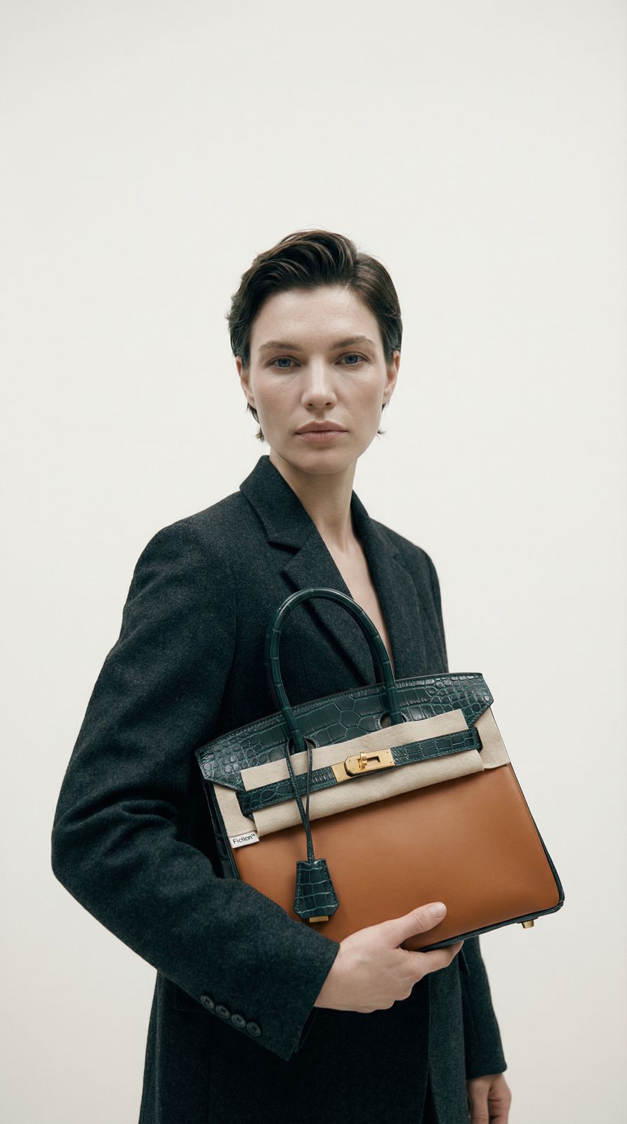 a woman holding a brown and black purse
