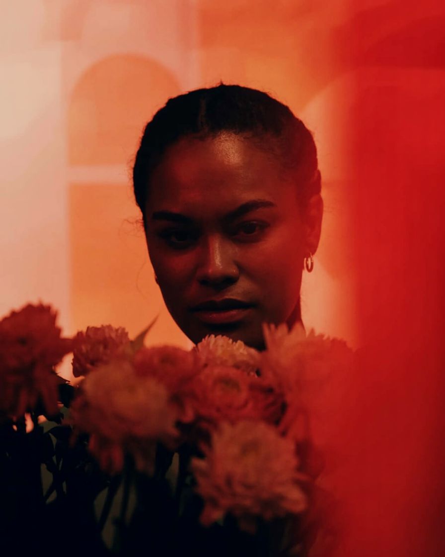 a woman holding a bunch of flowers in her hands