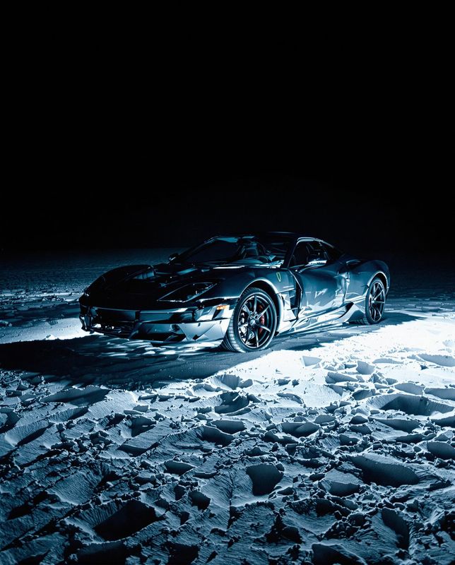 a sports car is parked in the snow