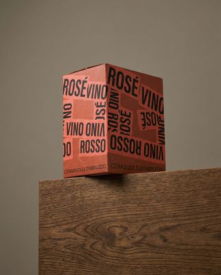 a stack of red boxes sitting on top of a wooden table