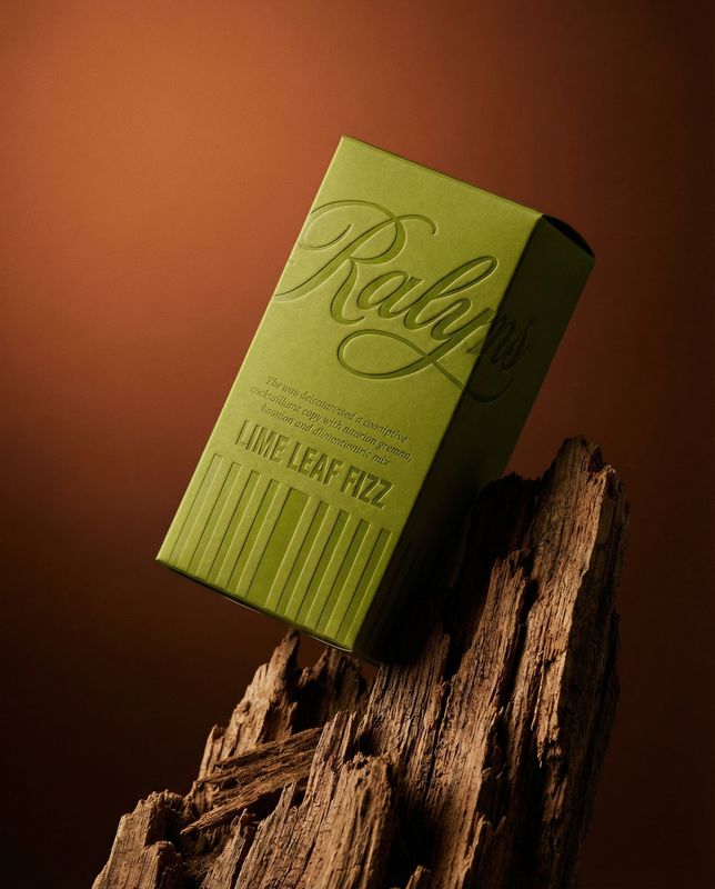 a green box sitting on top of a piece of wood