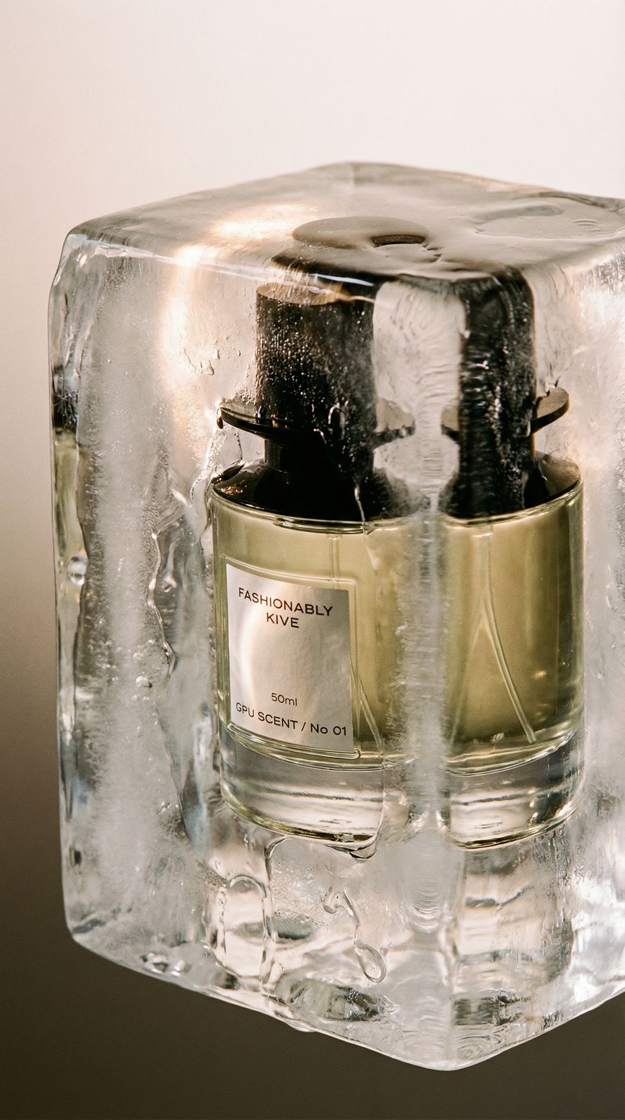 a couple of bottles of perfume sitting on top of a block of ice