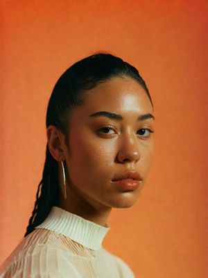 a woman with a ponytail wearing a white shirt