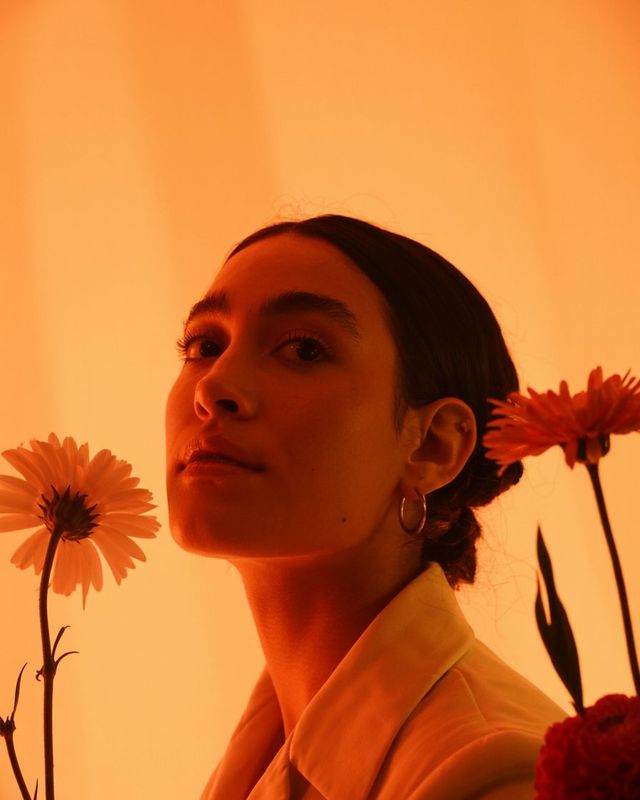 a woman with a flower in her hand