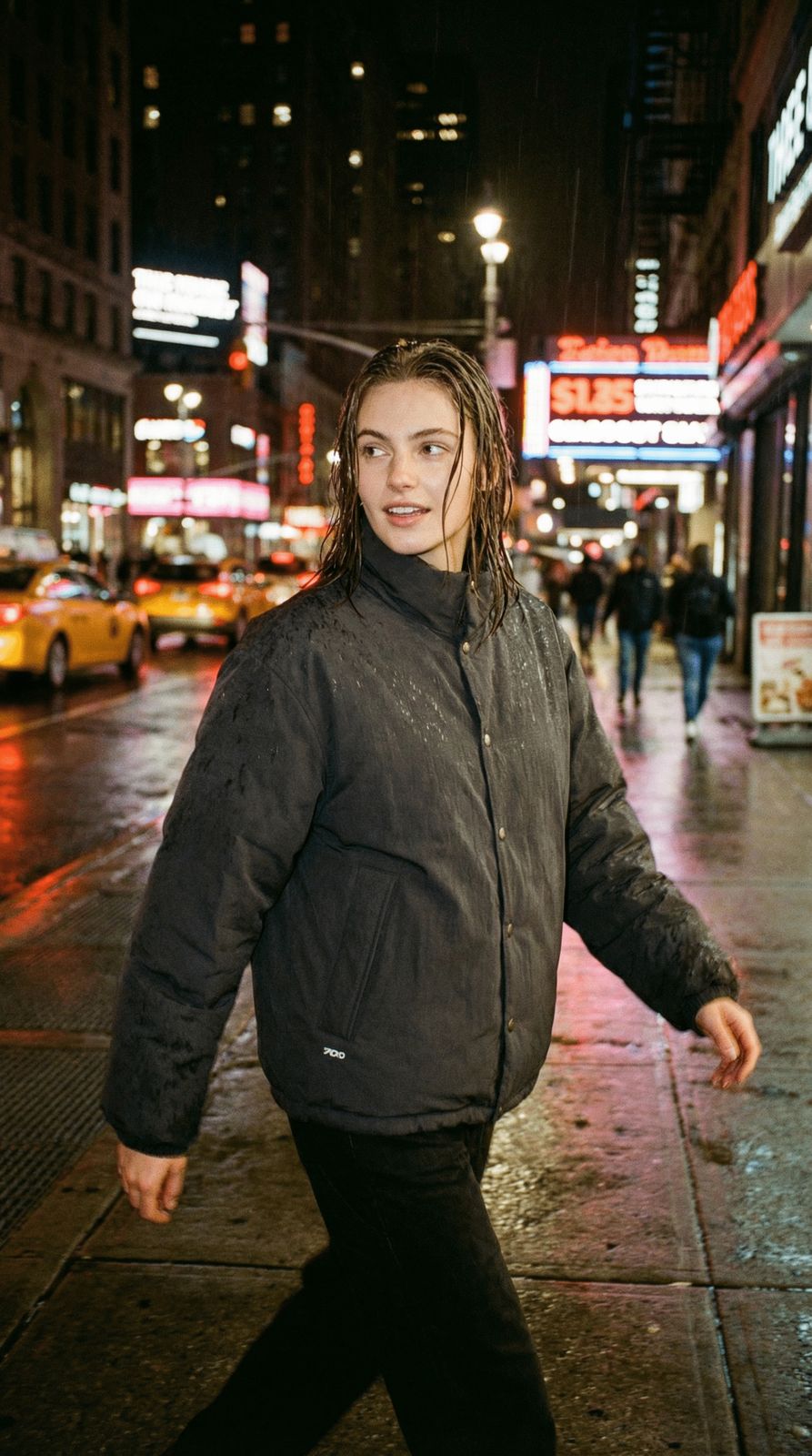 a woman is walking down the street in the rain