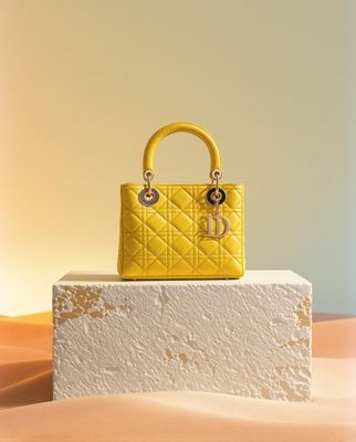 a yellow purse sitting on top of a white block