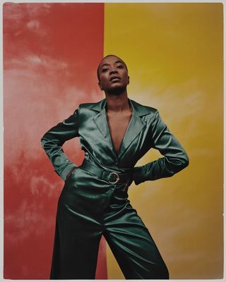 a woman standing in front of a colorful wall