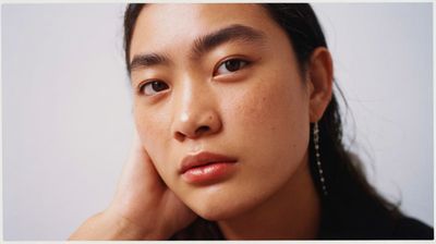 a close up of a person wearing earrings