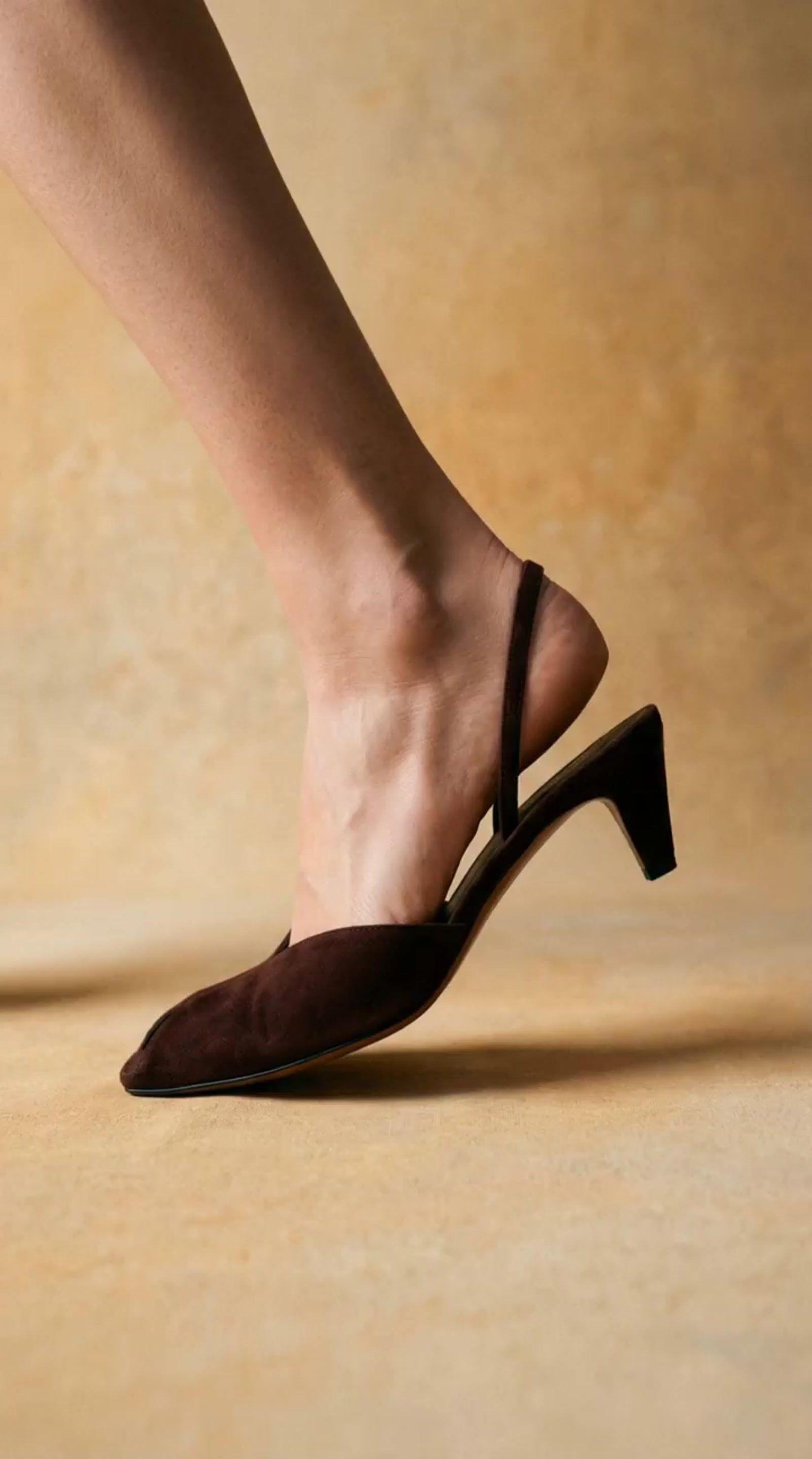 a close up of a person's feet wearing high heels