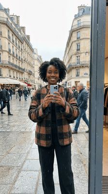 a woman taking a picture of herself in a mirror