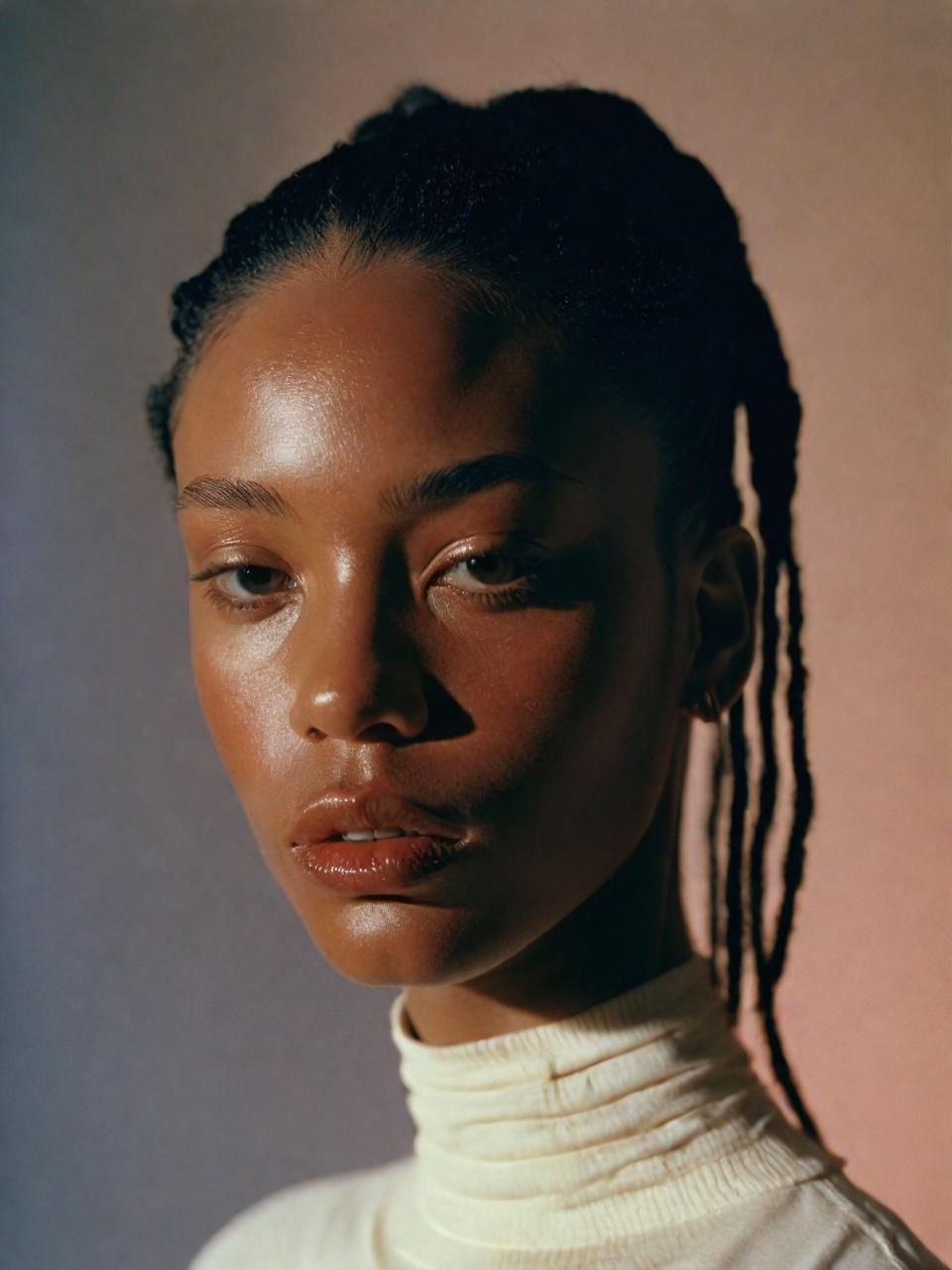 a woman with dreadlocks and a turtle neck sweater