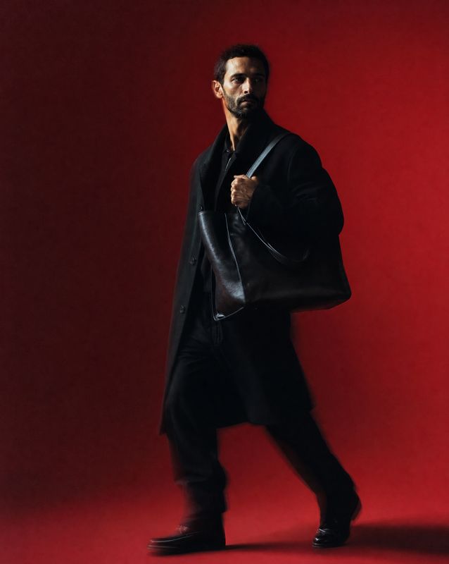 a man in a black coat and black pants
