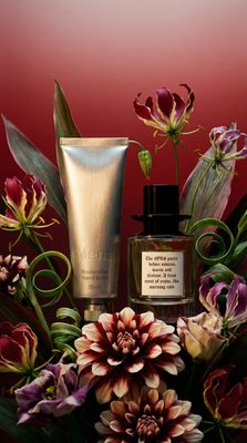 a bouquet of flowers and a bottle of perfume