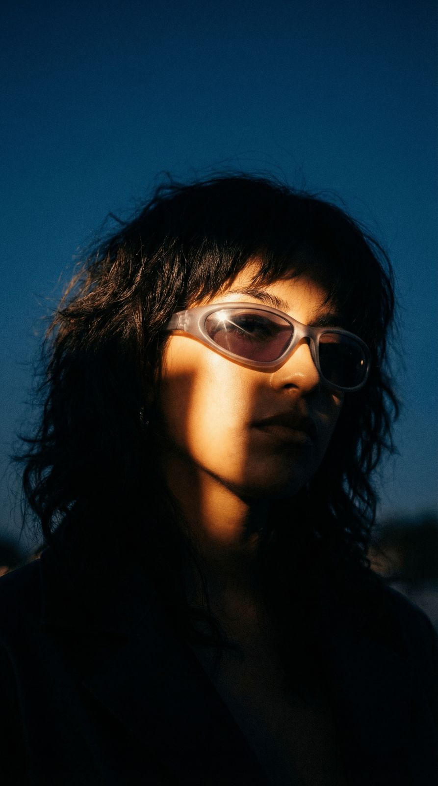 a woman wearing sunglasses and a black shirt