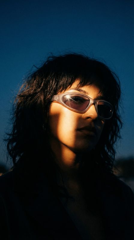 a woman wearing sunglasses and a black shirt