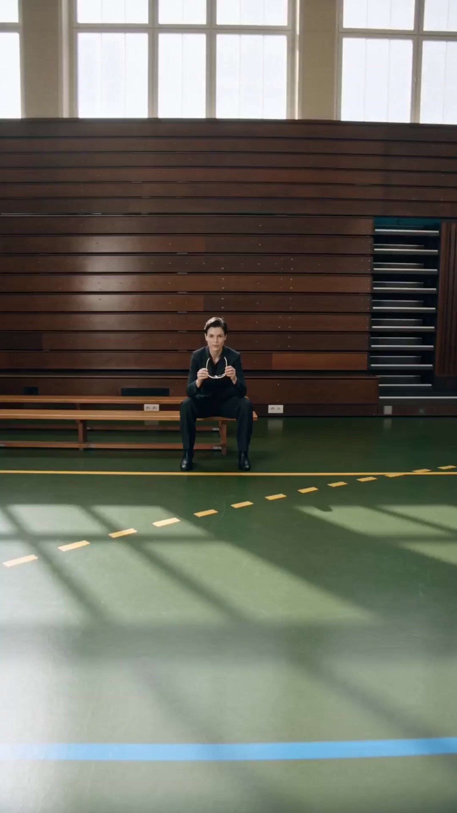 a man sitting on a bench in a gym