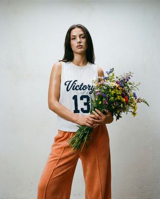a woman holding a bunch of flowers in her hands
