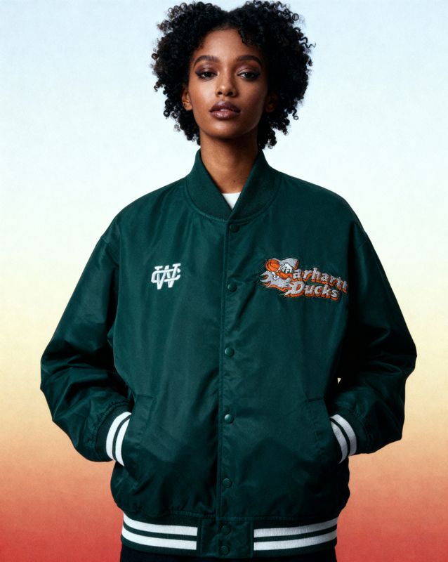 a woman wearing a green jacket and black pants