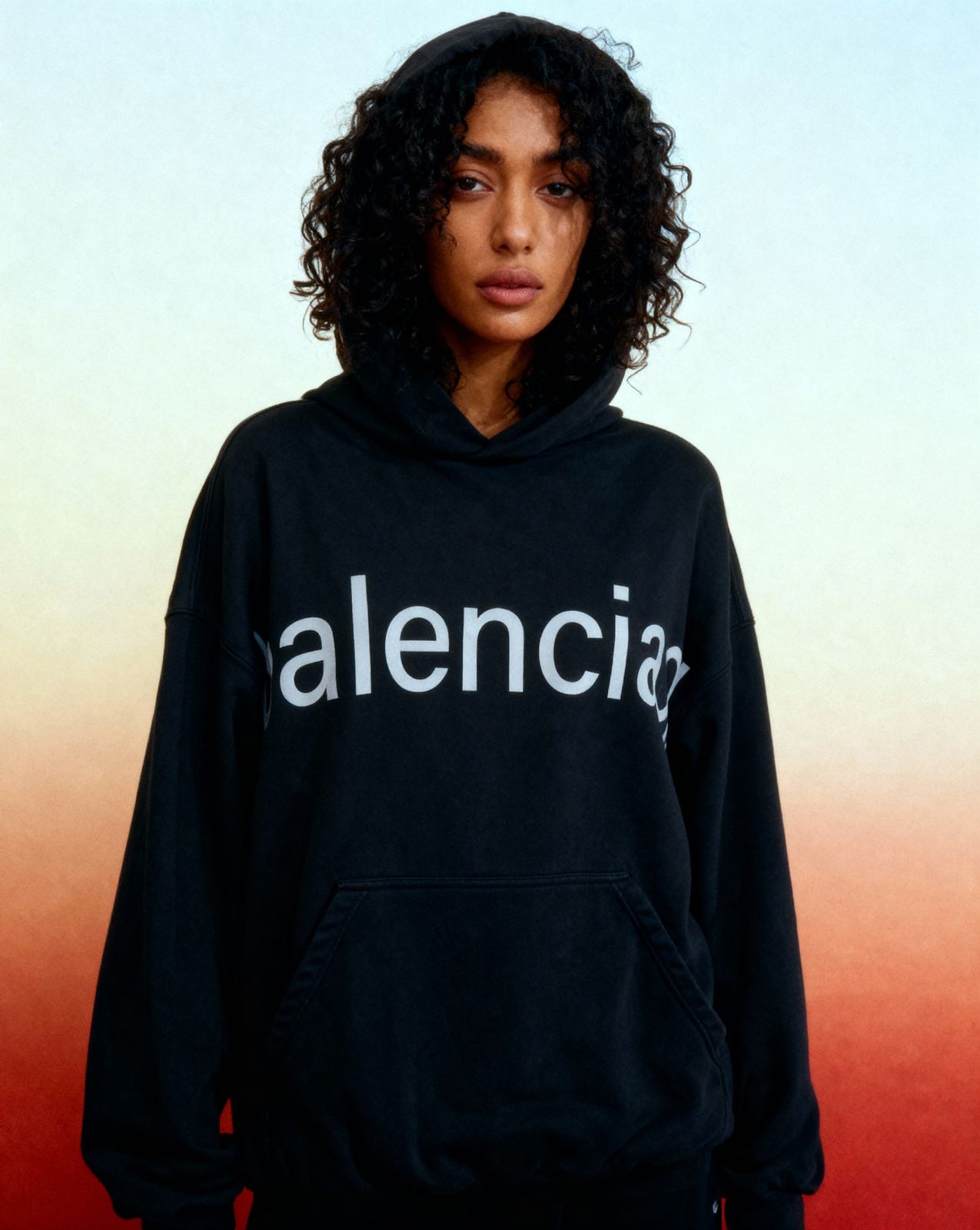 a woman wearing a black sweatshirt with the word alencia printed on it