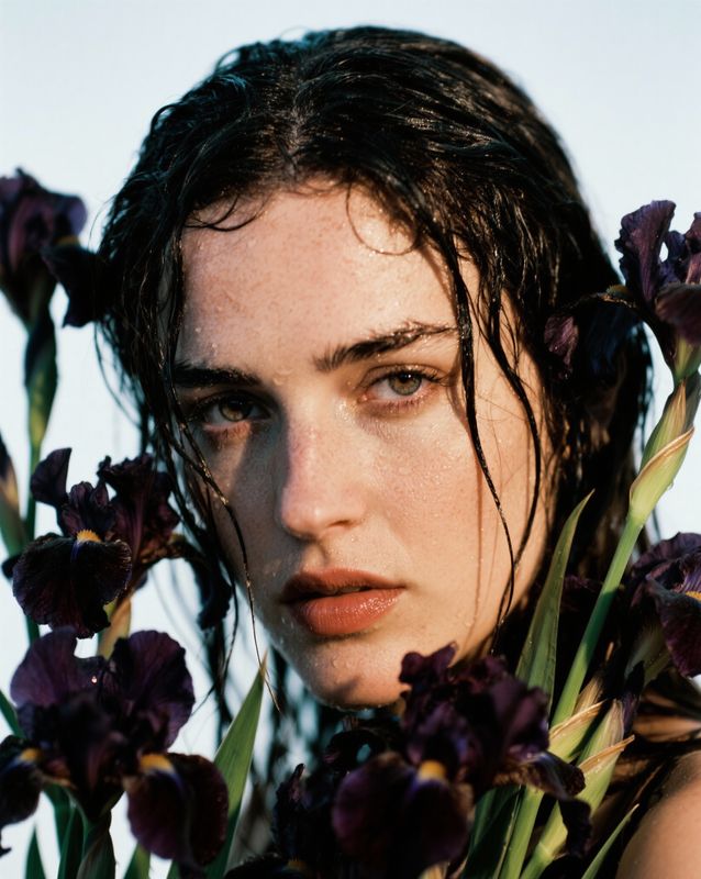 a close up of a person with flowers in their hair