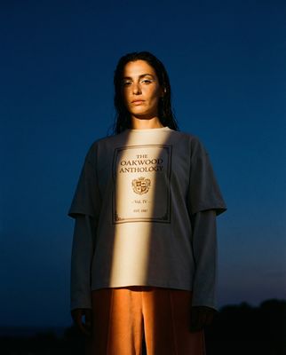 a woman standing in front of a blue sky