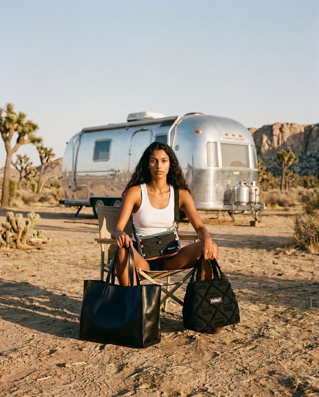 a woman sitting on a chair in front of a trailer