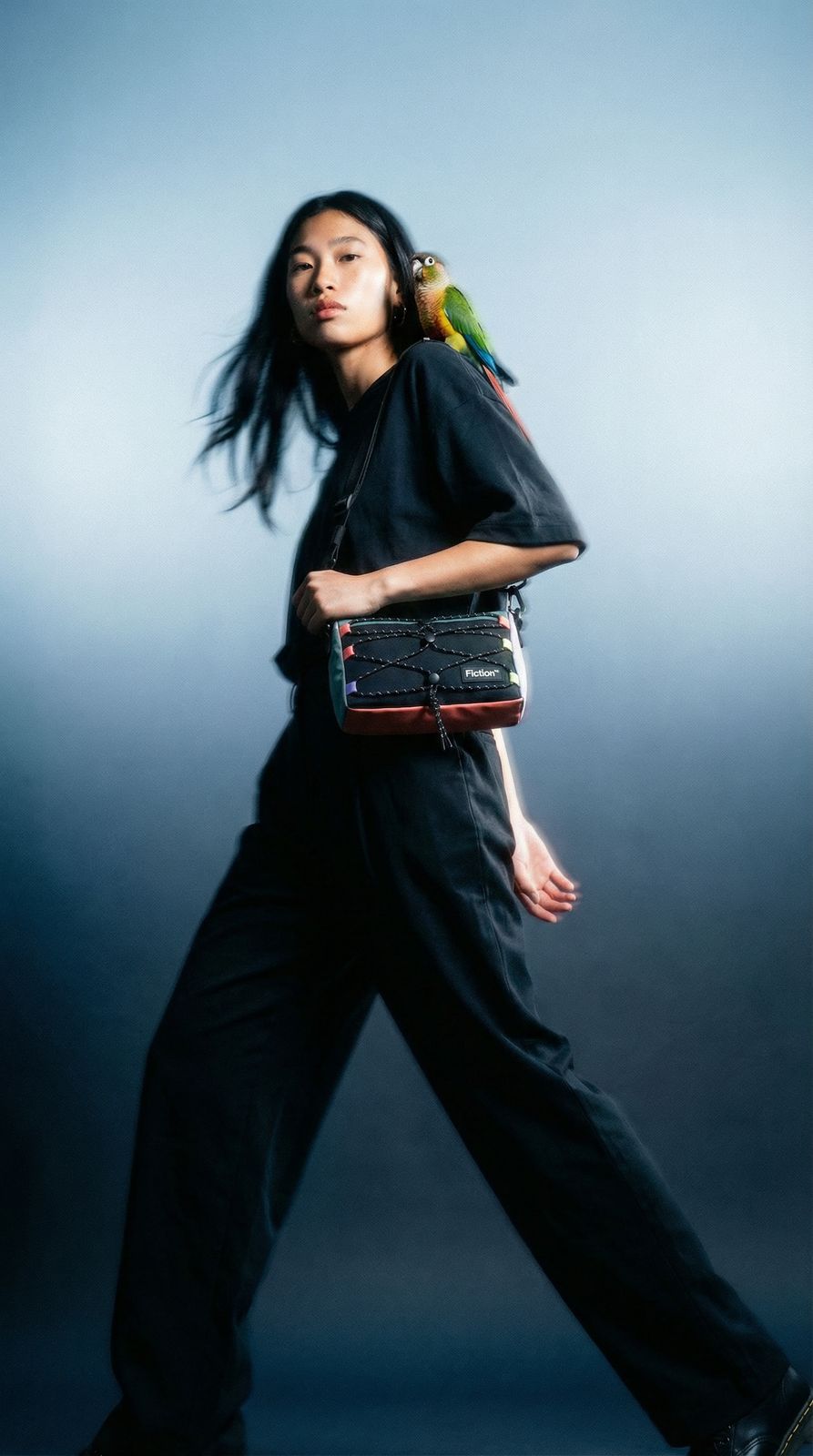 a woman with a bird on her shoulder