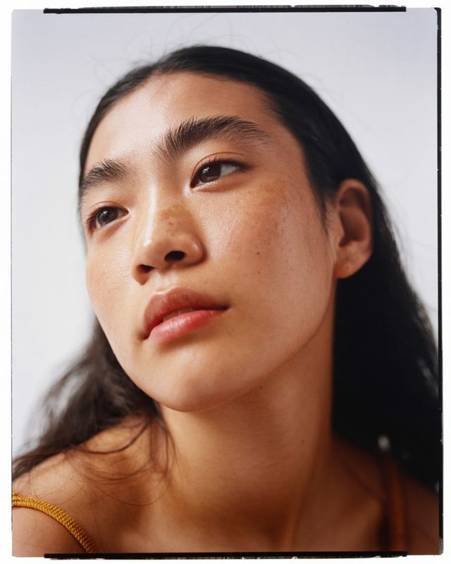 a close up of a person wearing a necklace