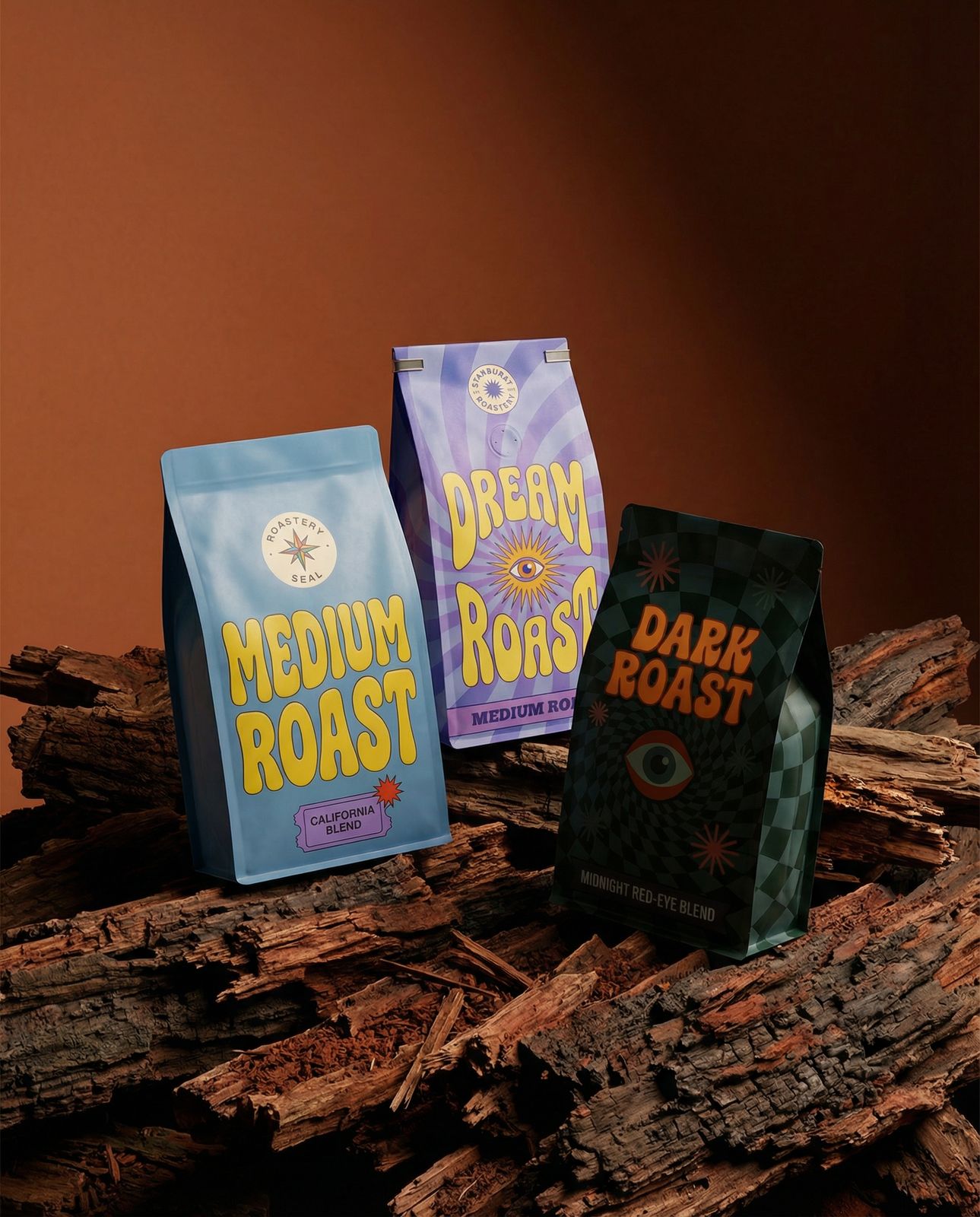 three bags of coffee sitting on top of a pile of wood